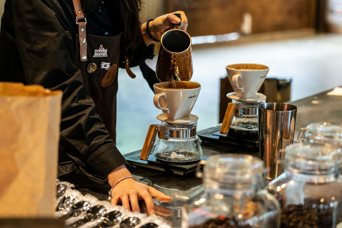 Hands brewing pour-over coffee