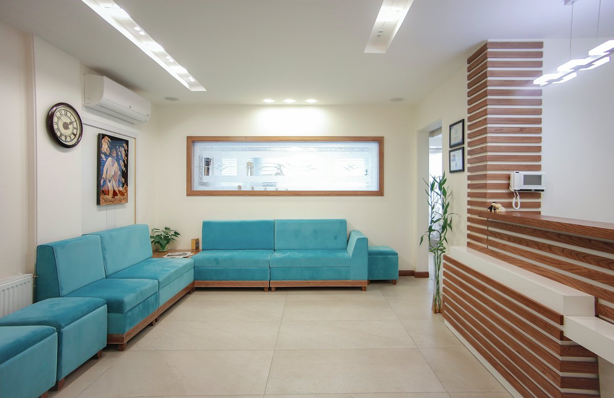 The waiting area with teal sofas