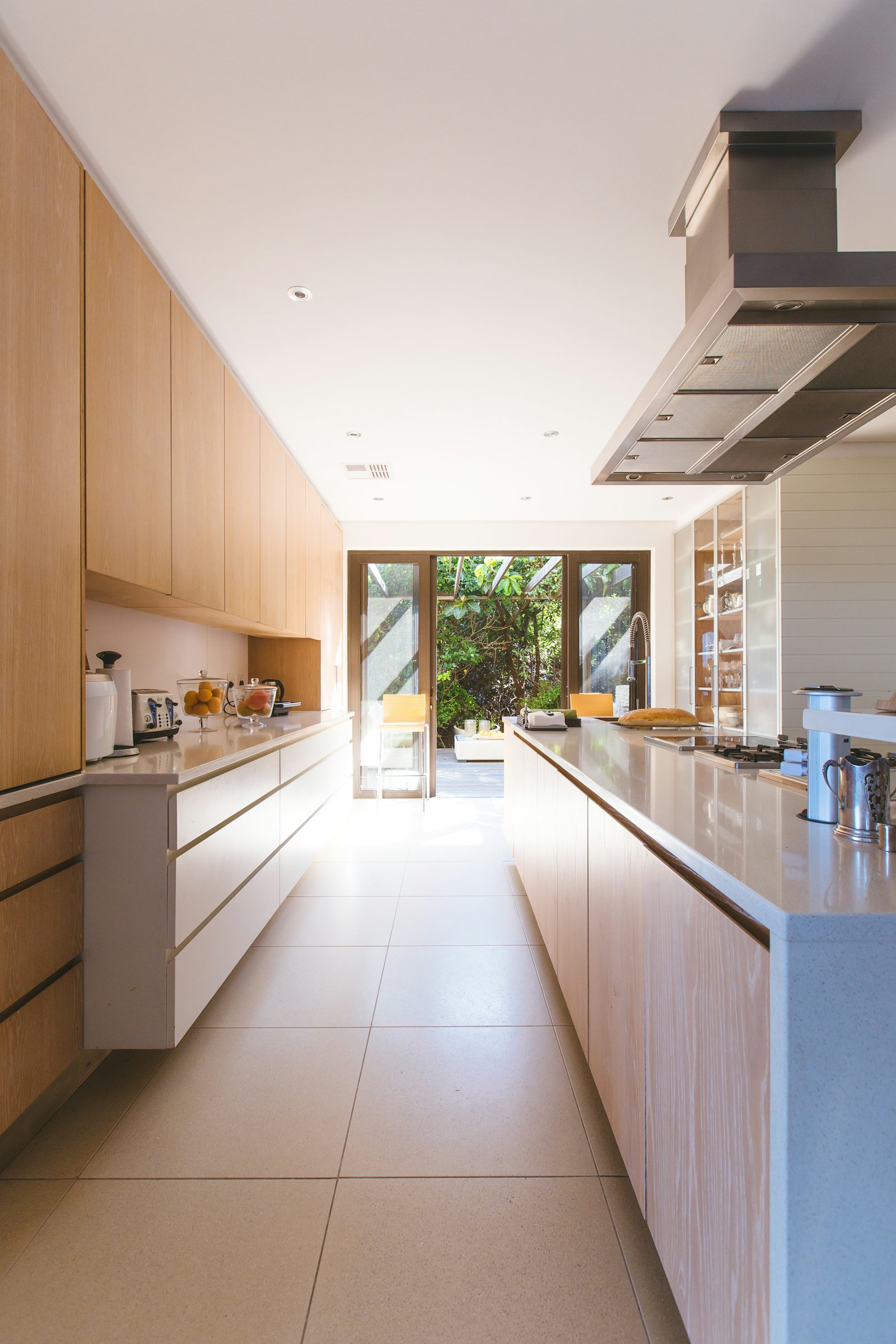 A long kitchen with timber cabinetry