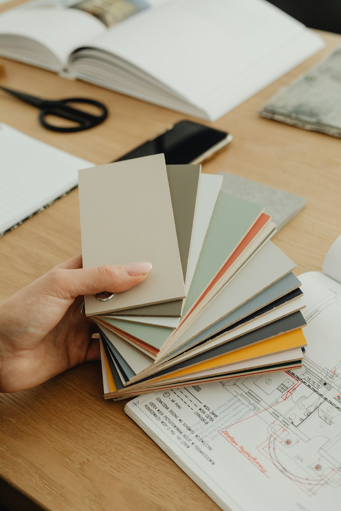 A hand holding material swatches