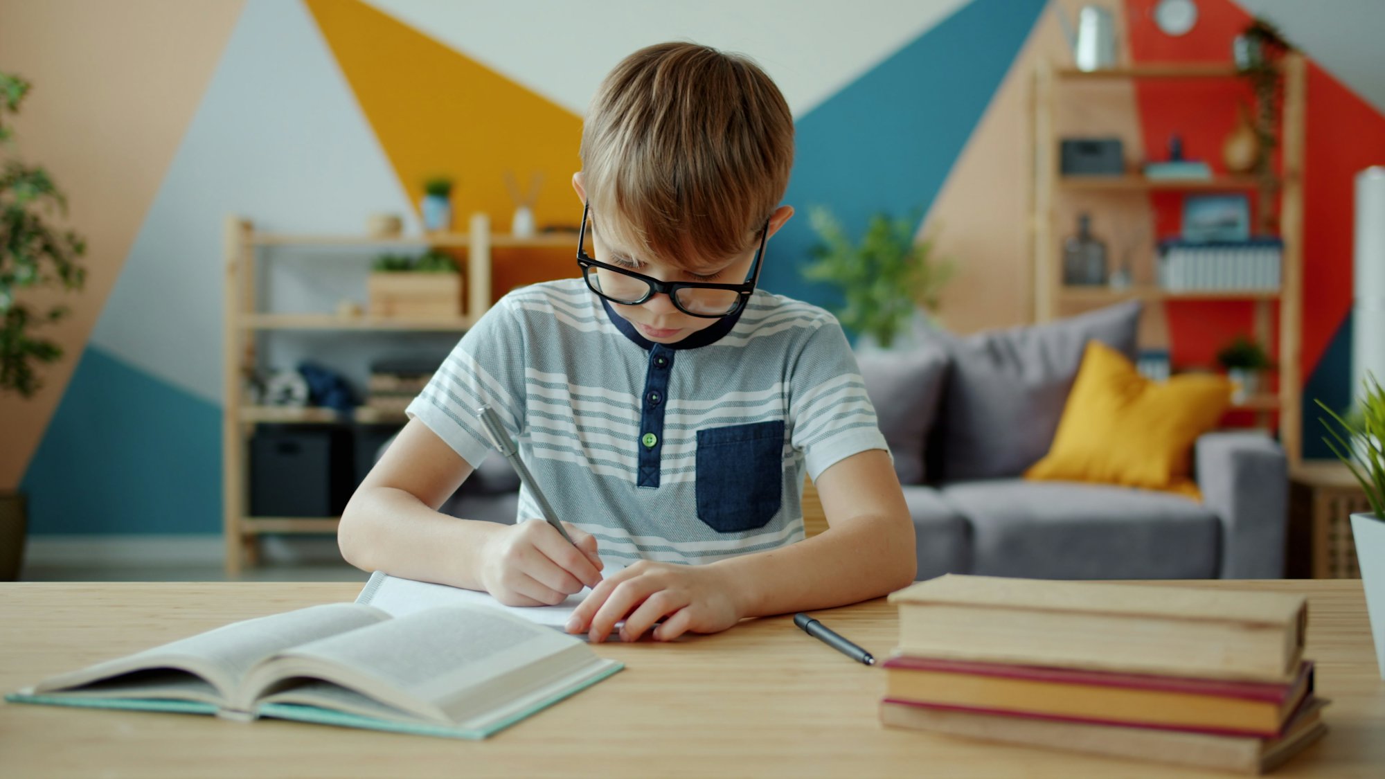 A student concentrating on homework at a bright desk