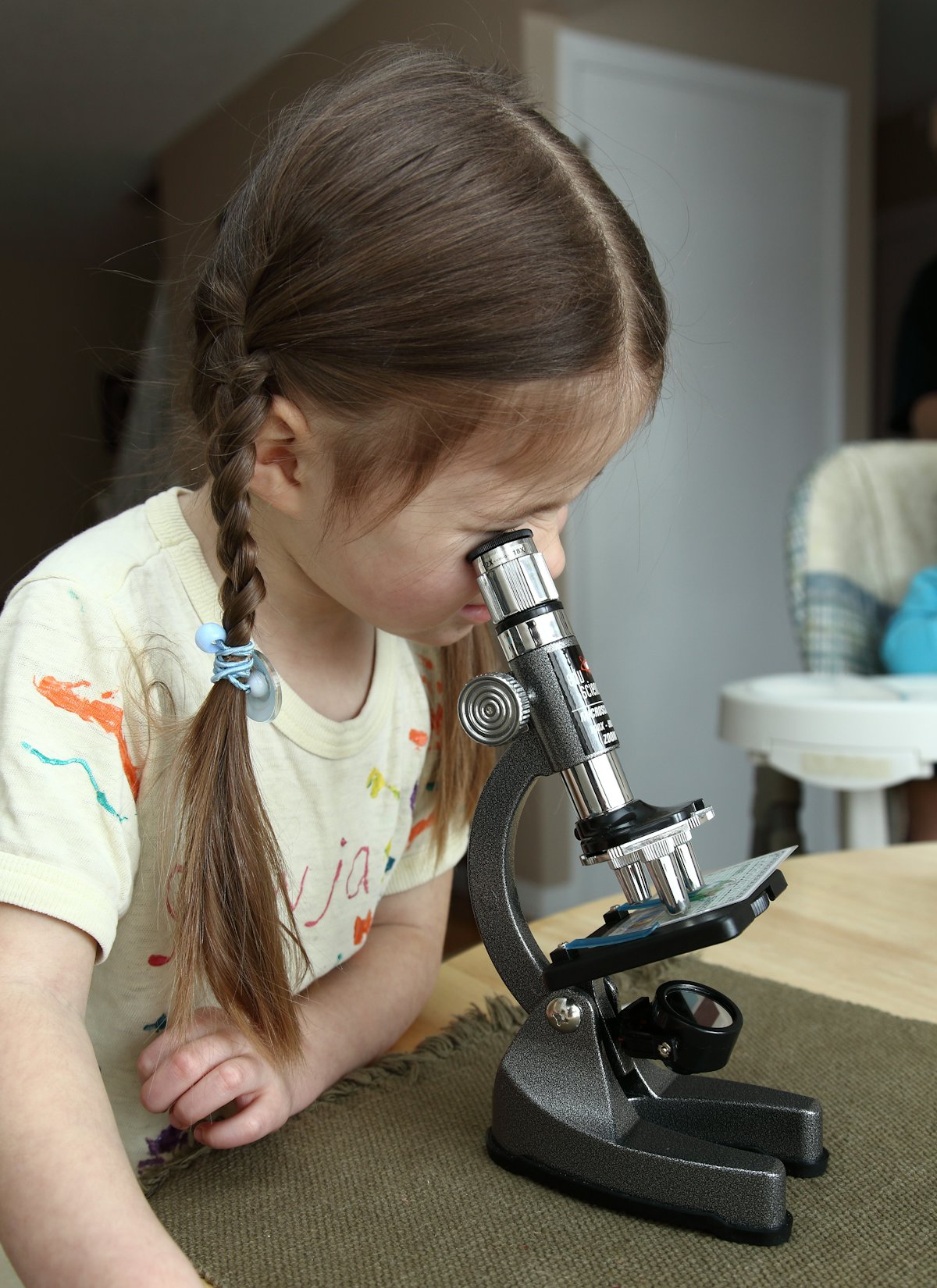 A student looking through a microscope